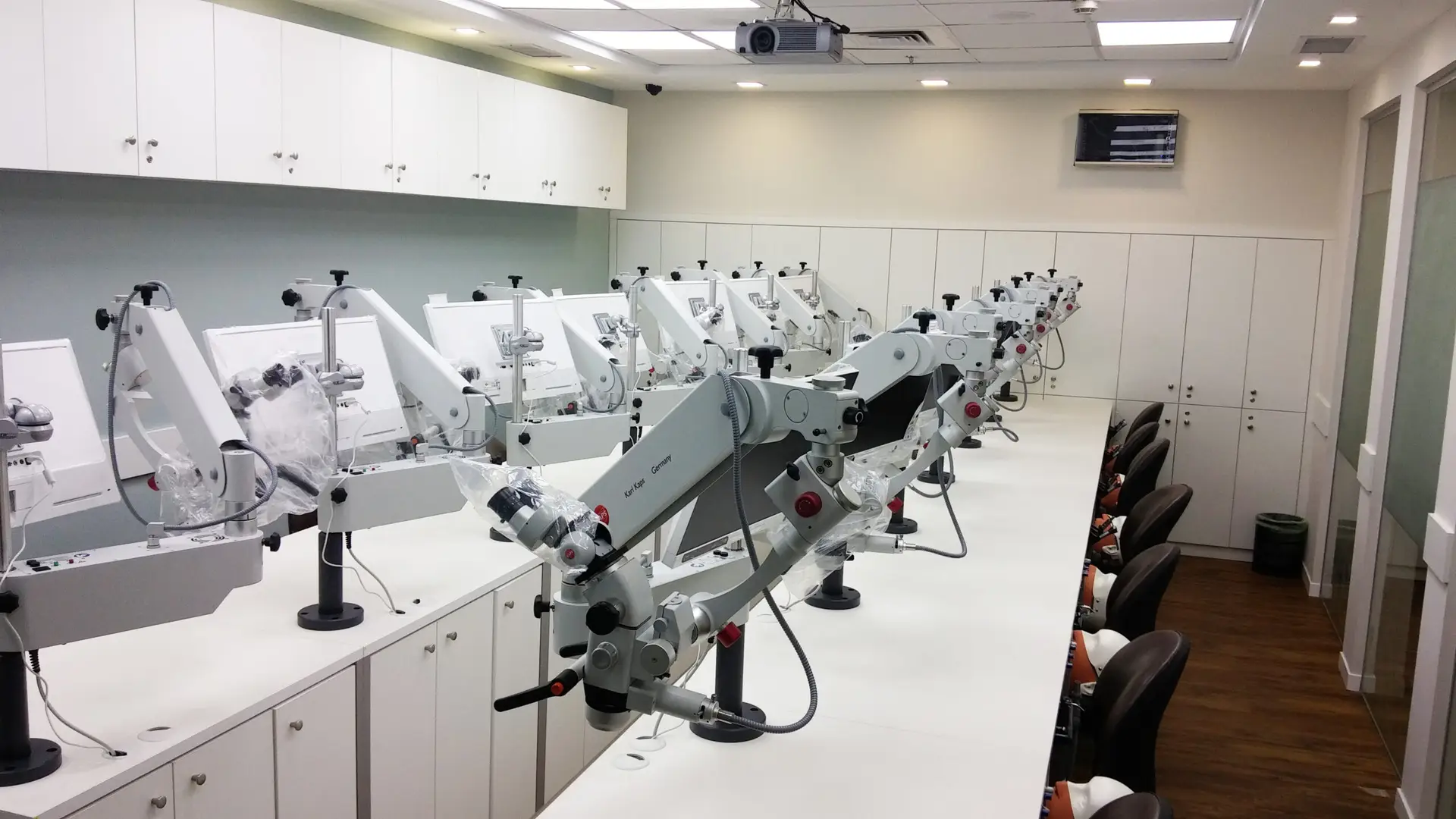 Lab classroom of Karl Kaps Microscopes made in Germany on white tables, arranged for professionals to learn.